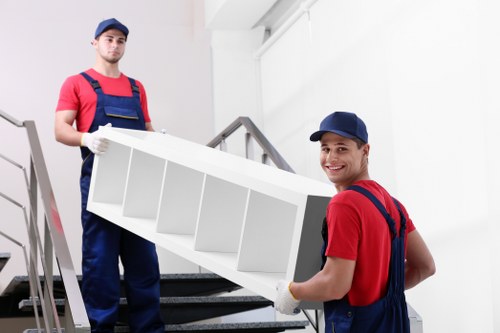 Movers carrying boxes during a small removal service